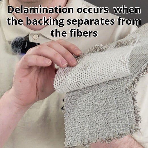 close up of carpet backing separating from the fibers